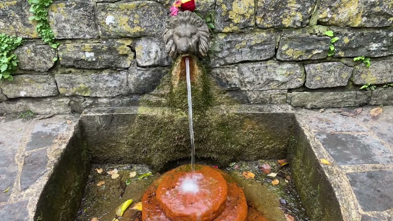 Red Iron-Rich Water at The Lions Head Spring, The Chalice Well, Glastonbury, UK