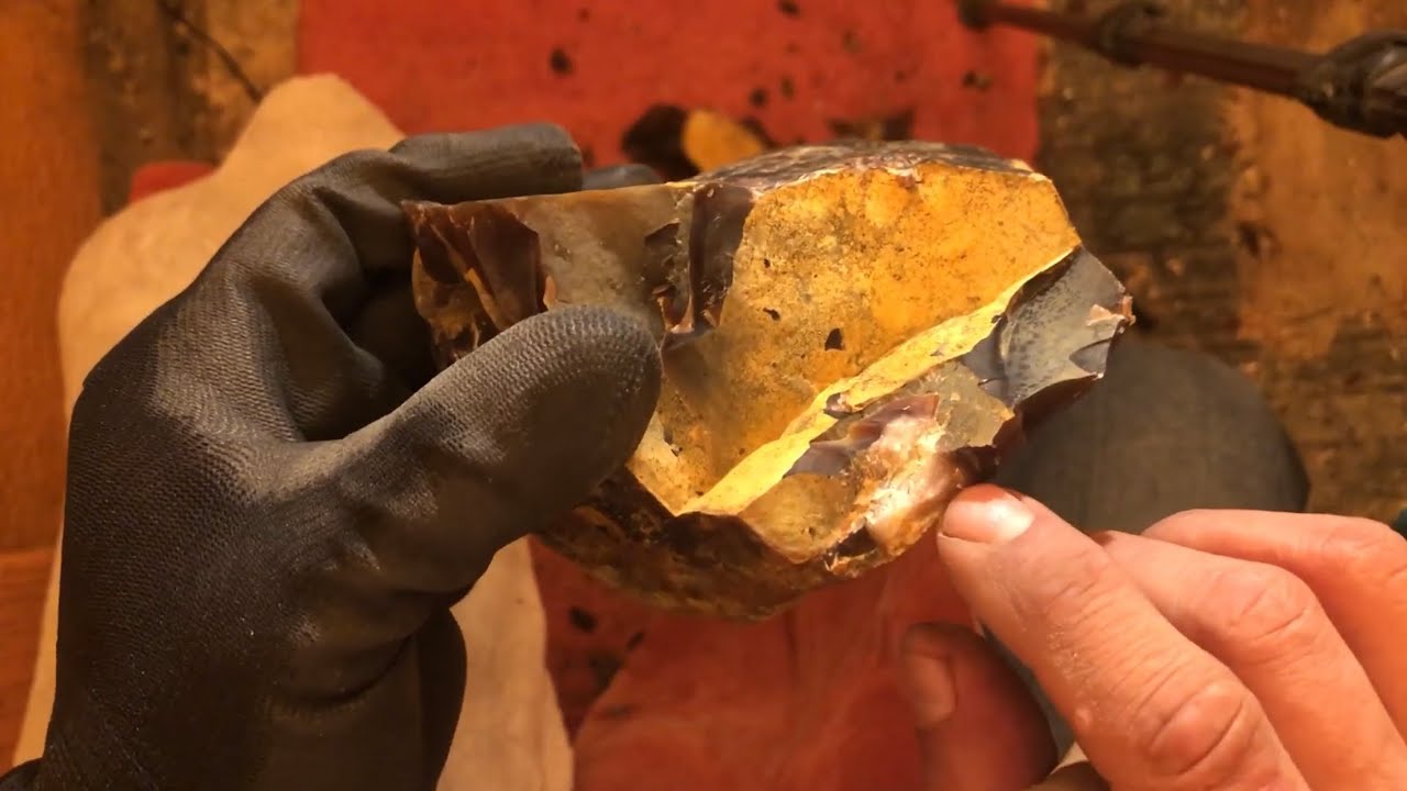 Spalling Knife River Flint rocks with copper bopper