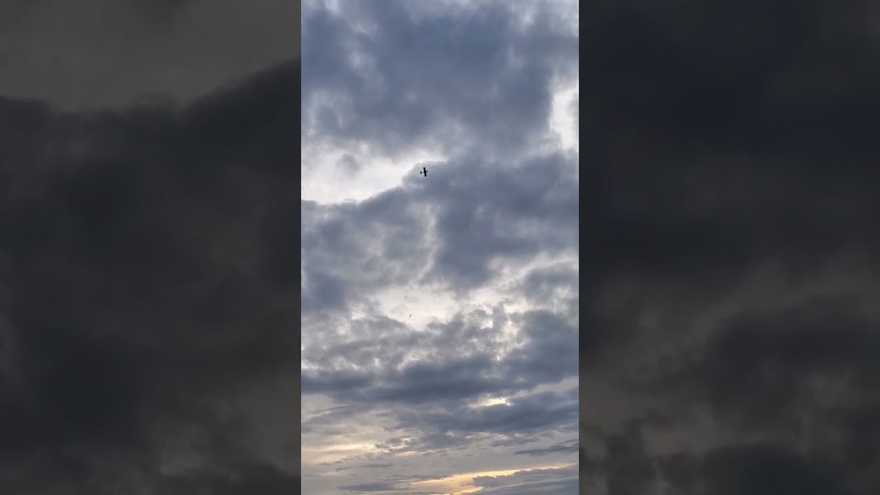 two sport planes flying in formation 