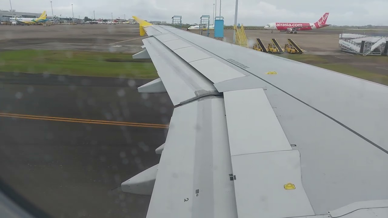 Cebu Pacific A320 takeoff with light rainshower at Mactan Cebu International Airport 