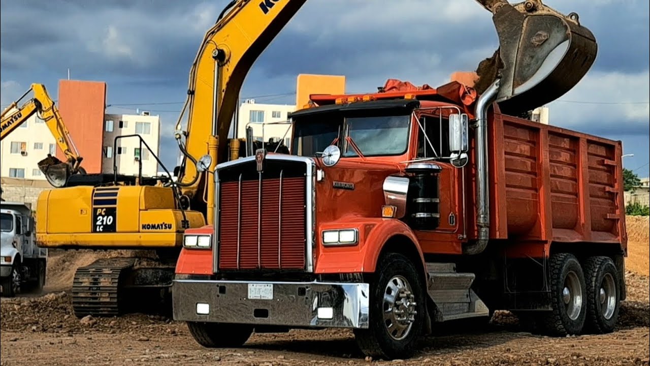 Komatsu PC210LC Excavators Load Dump Trucks with Excavated Material