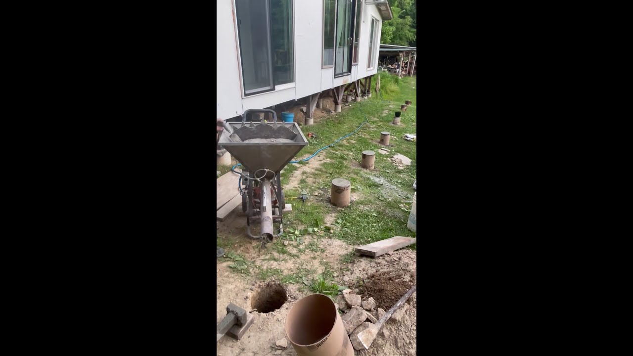 Pouring concrete piers fast and easy,diy mudmixer, diy cement mixer in action.