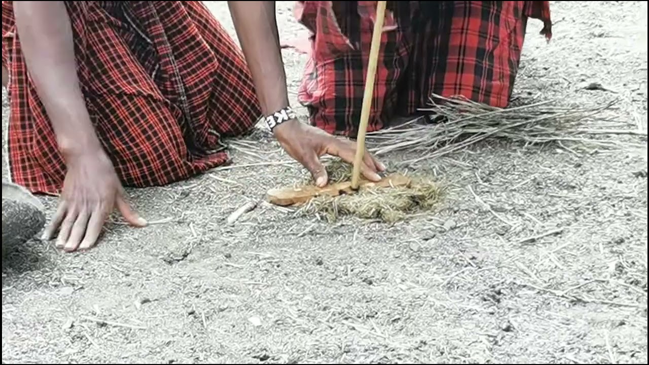 Drill wood to make fire in Masai Mara , Kenya 