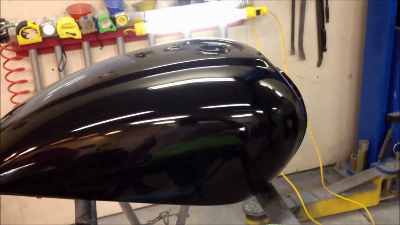 Finishing a paint job on motorcycle a gas tank at the UGG, sanding and detail work