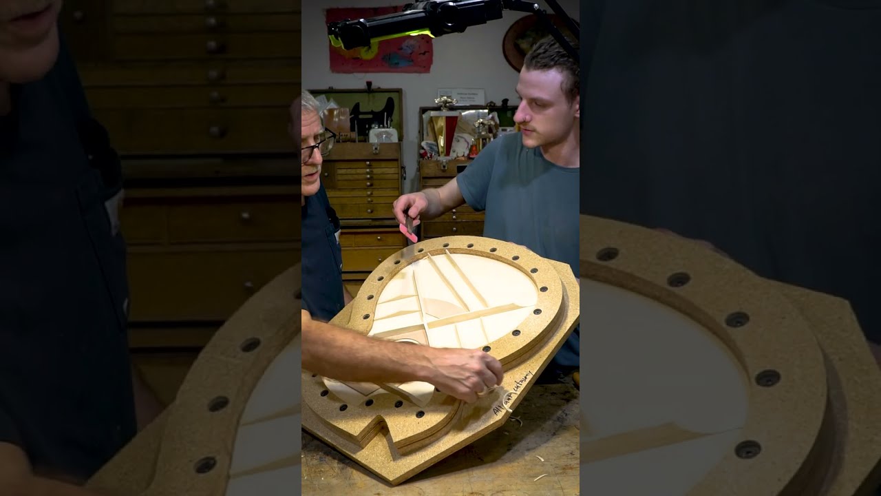Master luthier Bryan Galloup teaches instrument voicing to his senior apprentice, Micah Holstein.