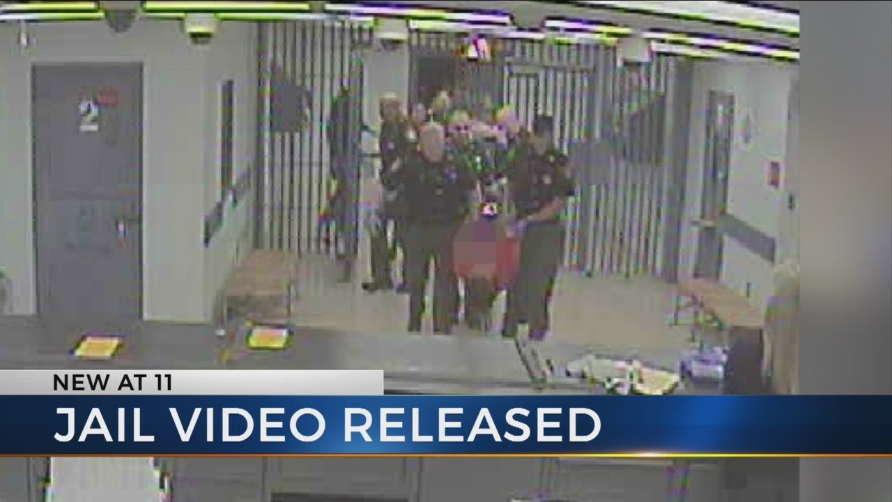 Booking video shows Timothy Davis being carried into jail
