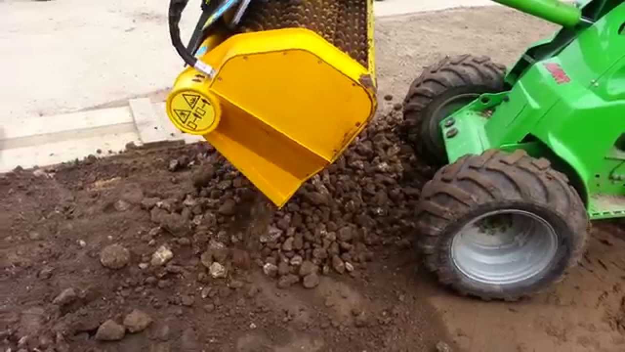 Gyru-star screening bucket used to prepare topsoil for lawn seeding project with an Avant Loader