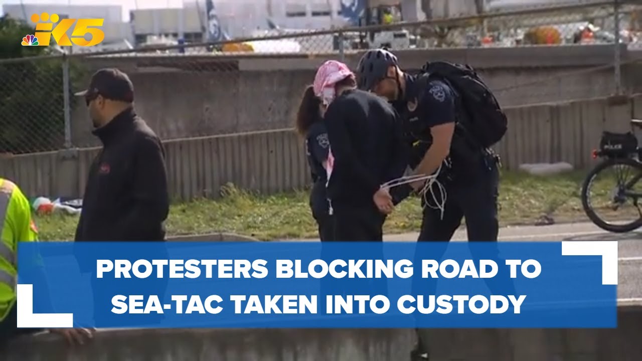 Protesters blocking road to Sea-Tac Airport being taken into custody