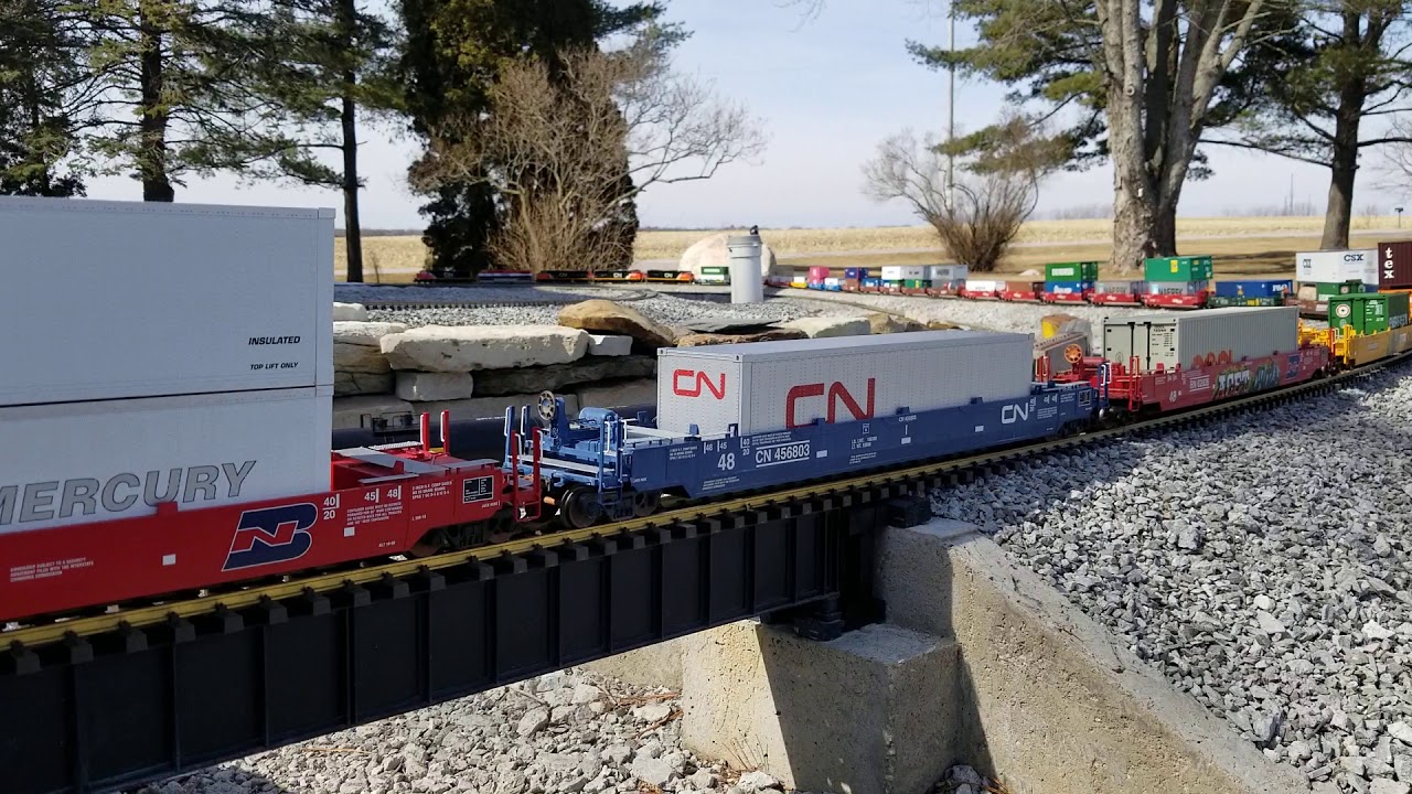 G scale garden railroad with CN dash-9's and sd70's pulling intermodal container cars