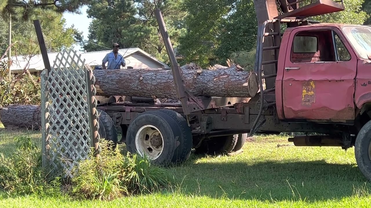 A pulpwood truck arrives at the Smith home to take some logs away to help get our yard cleaned up.