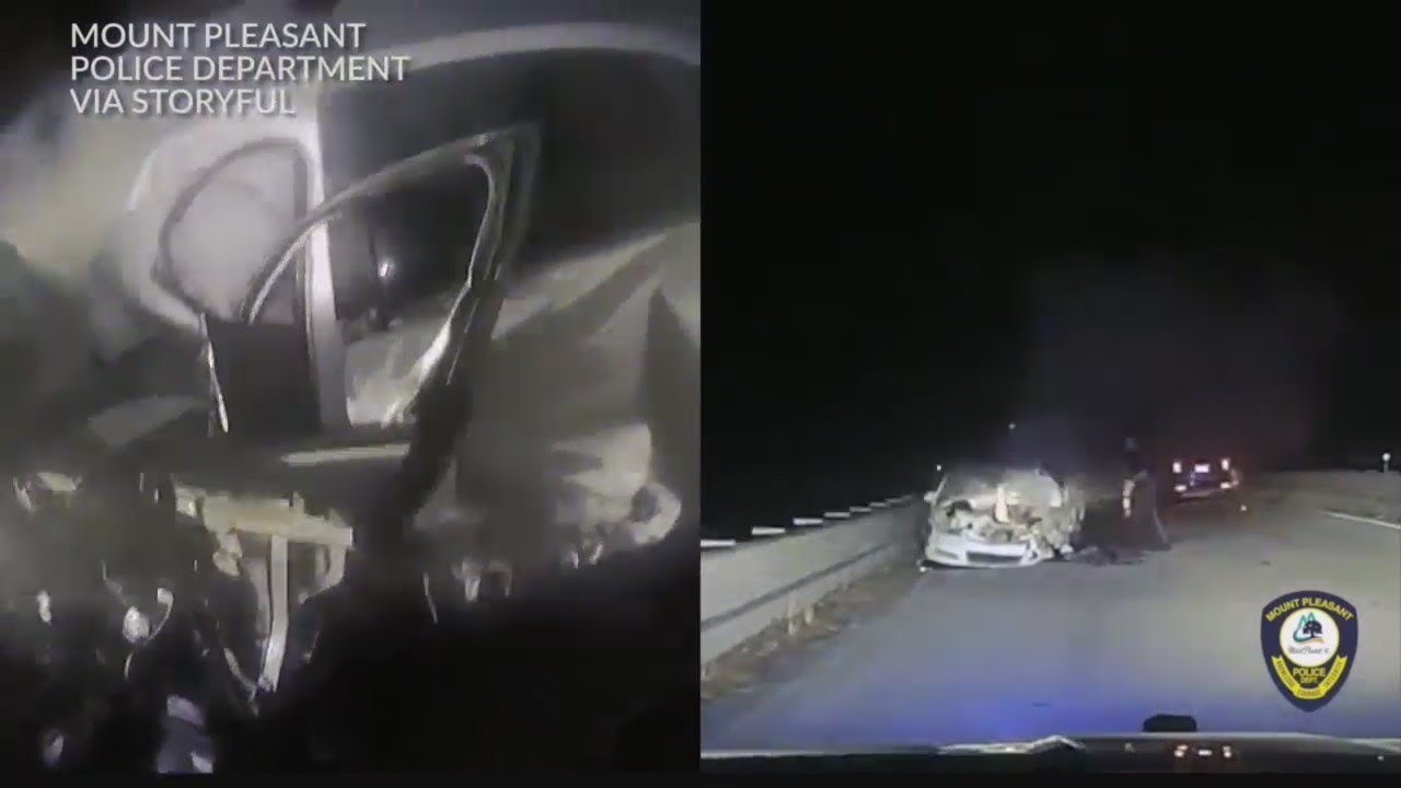 Police officer pulls woman from burning car