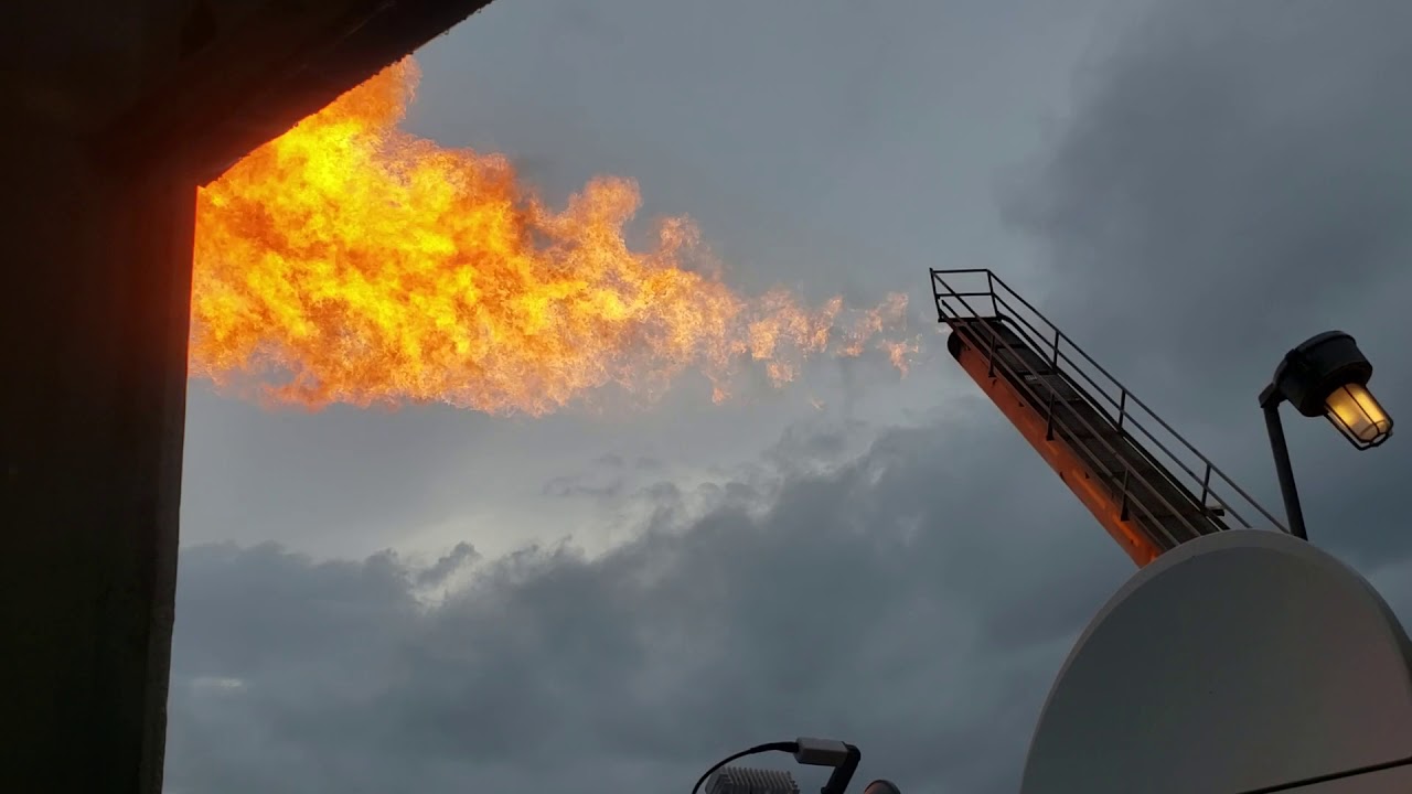 Offshore flare lit by lightning