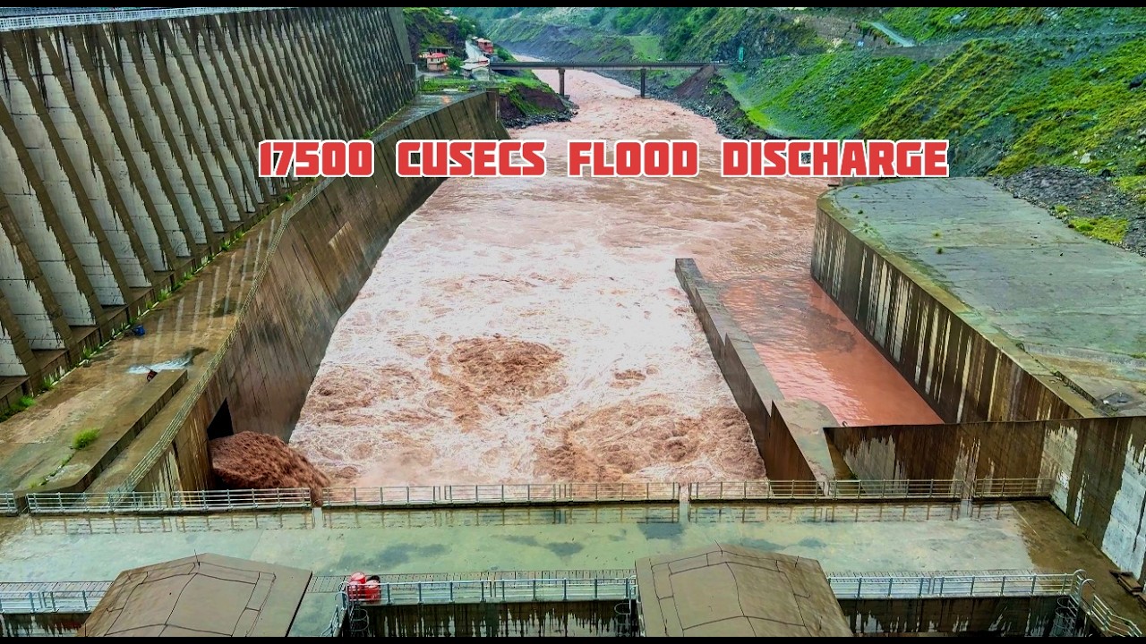 Massive volume of sediments released as the dam spillway gate opens before the storm