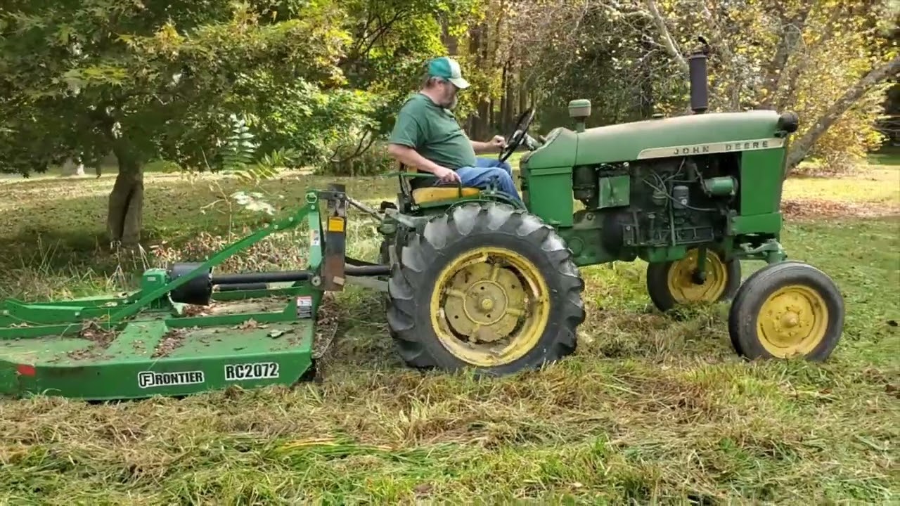 John Deere 1010RS doing yard work.