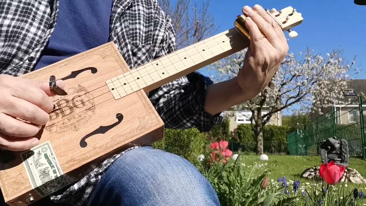 Jam on Hinkler Books The Blues Box Guitar. Modified with Ukulle Bridge an Furniture wedge :-)