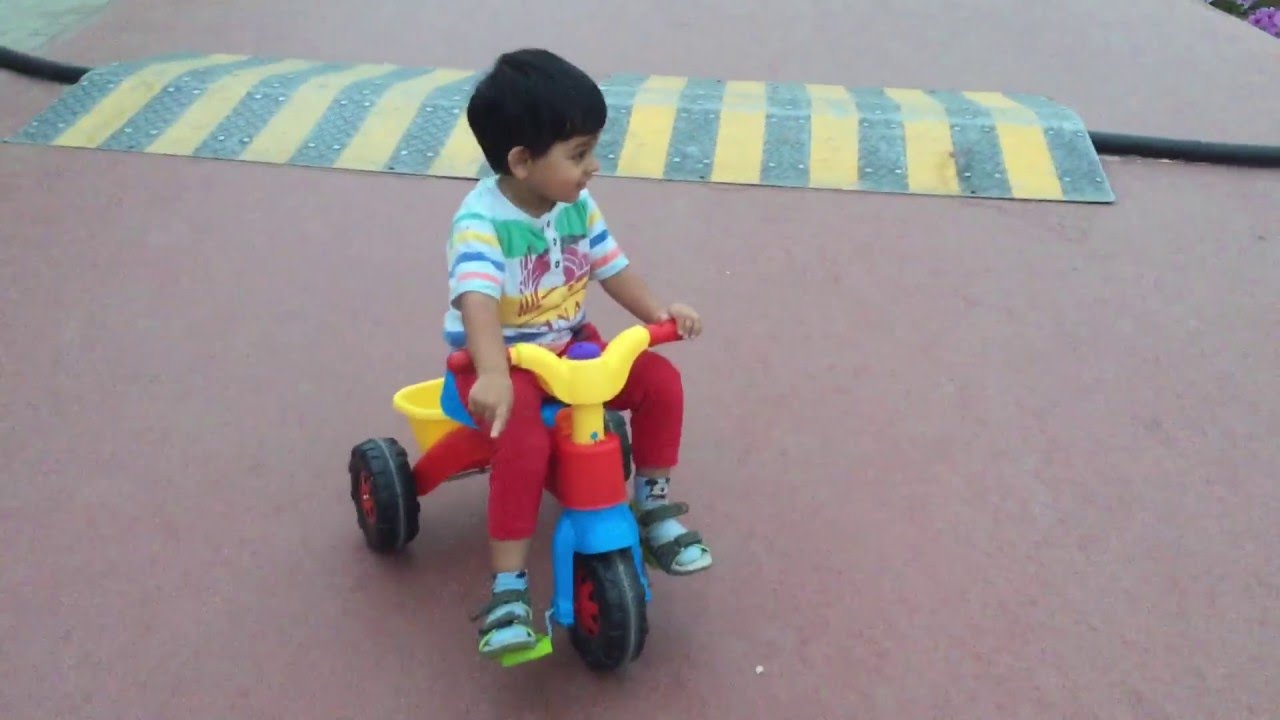 Baby riding tricycle.