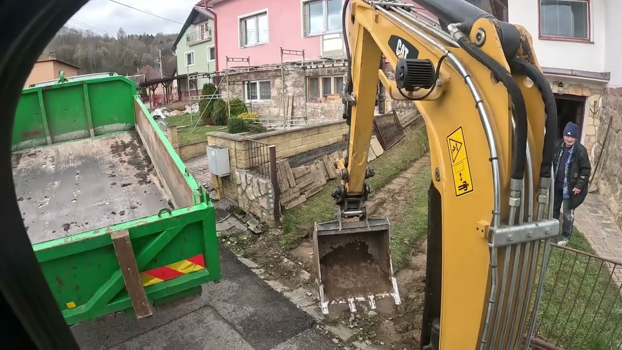 Podklad pod zámkovú dlažbu. Cat 302.7 excavator loading dump truck. CAB VIEW
