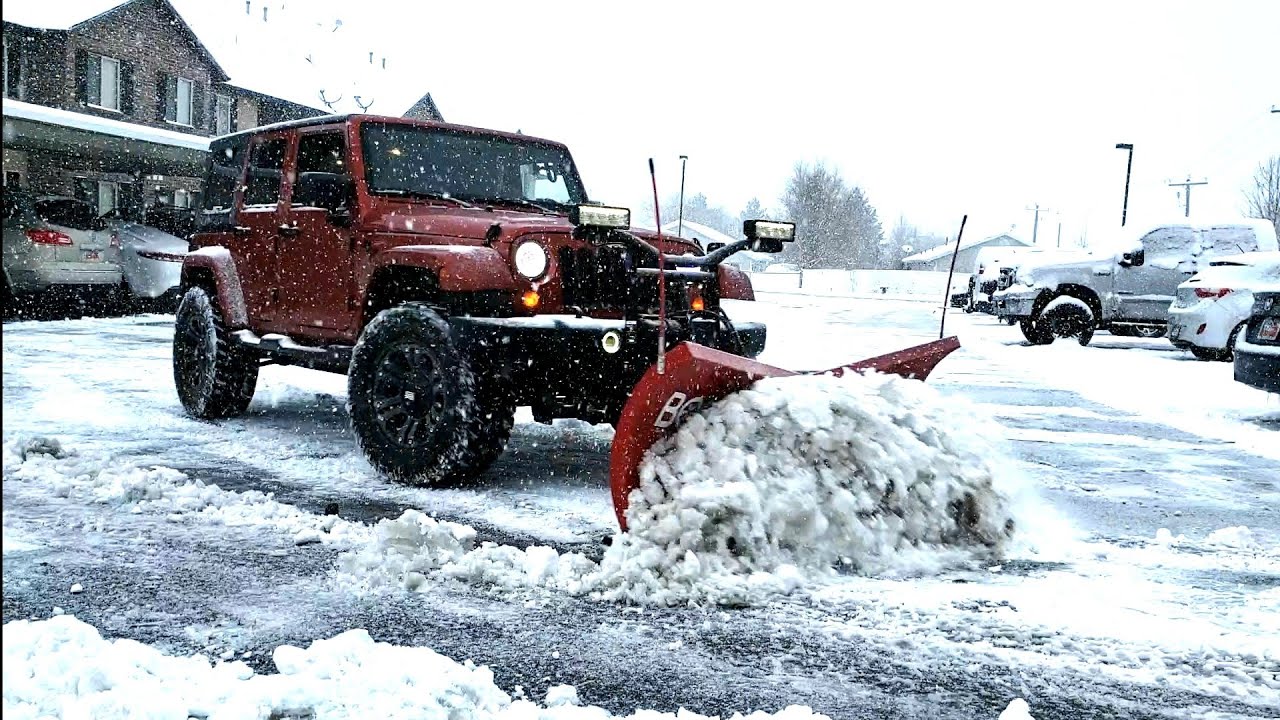 PLOWING SNOW WITH A JEEP WRANGLER AND BOSS HTX V PLOW. Snow removal of parking lot