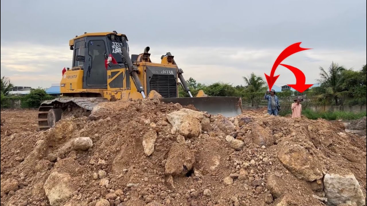 Continue work by Skilled SHANTUI DH17 c2 Bulldozer ￼Pushes Soils with Team heavy Dump trucks 