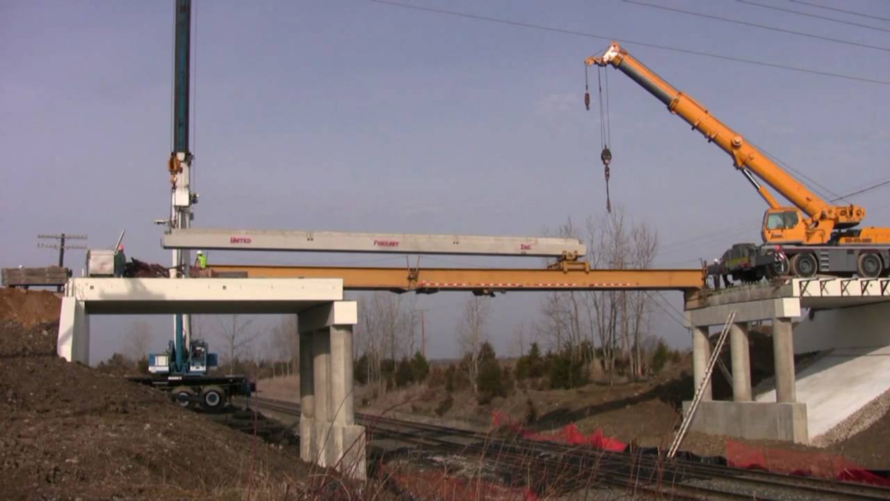 Jcrane sets bridge beams over railroad