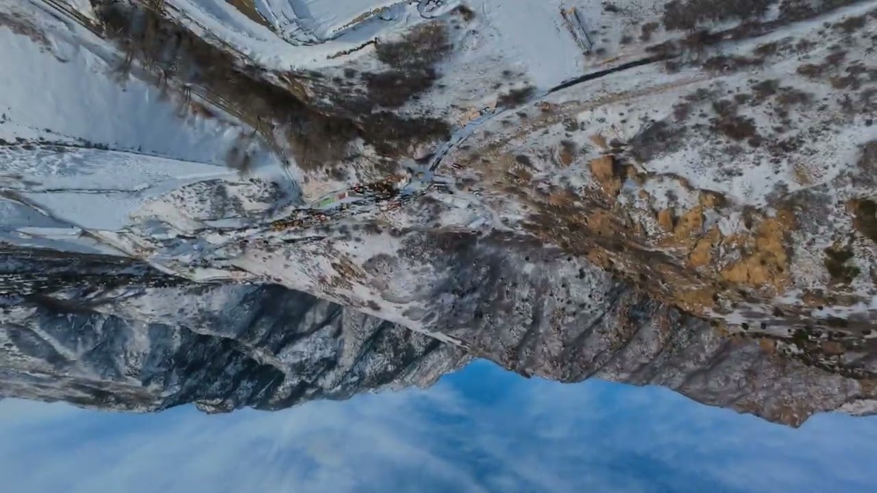 Ripping FPV over a snowy ridge with endless valley views 🏔️
