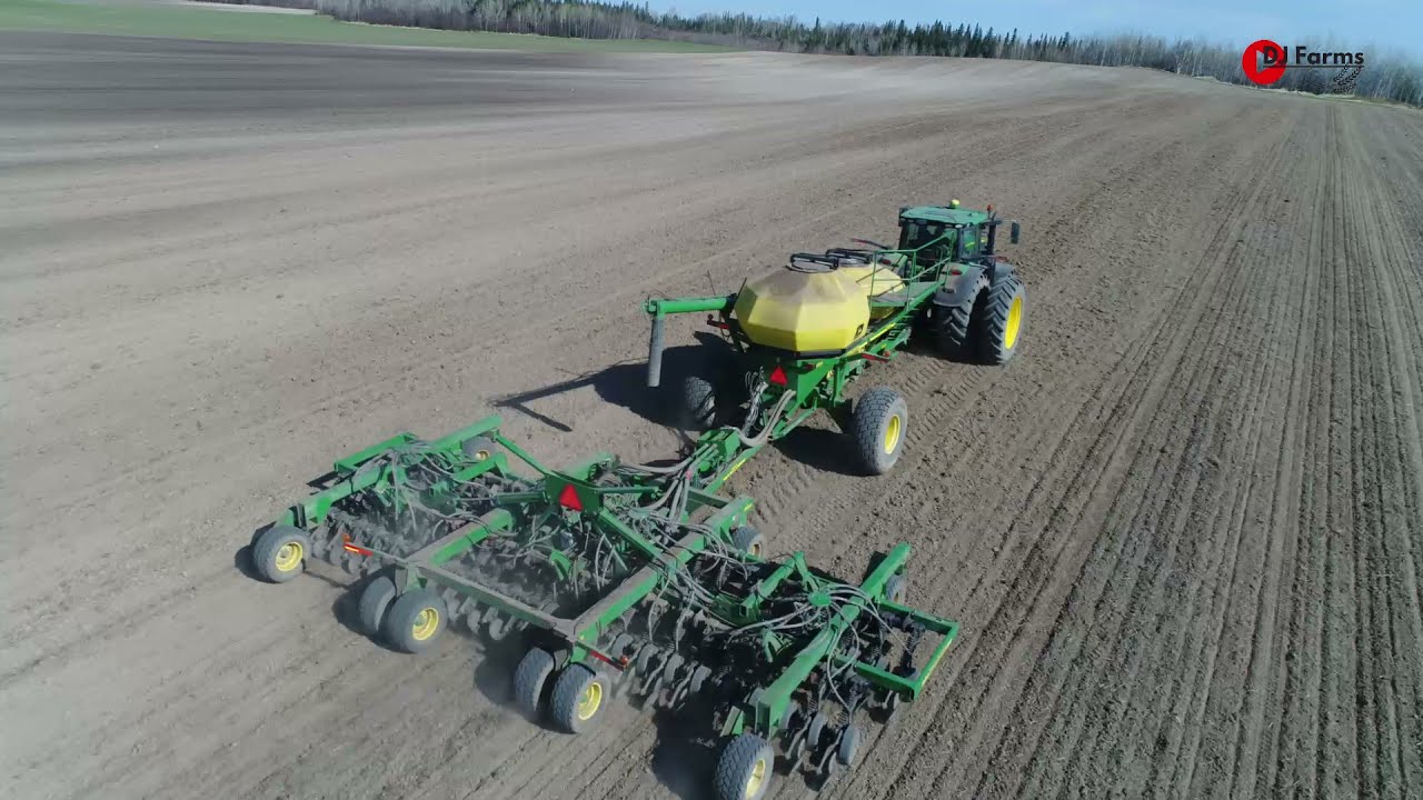 John Deere 6215R sur le semoir à air 1860 (air seeder ).