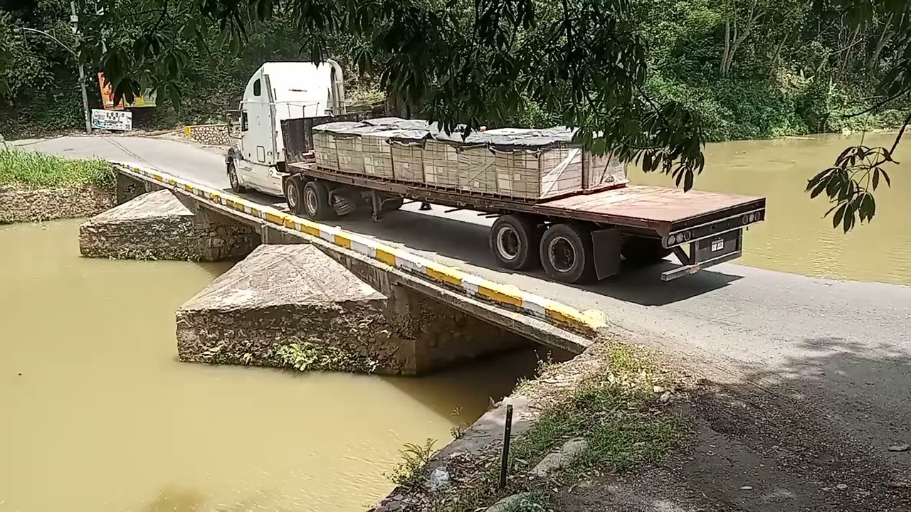 Trucks going across the most d@ngerous bridge in Jamaica 
