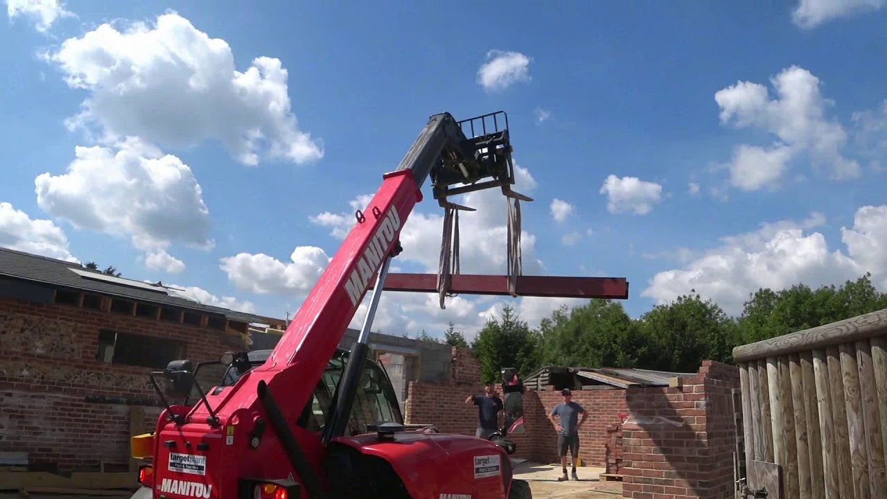 using a forklift to lift  heavy beams of oak and steel