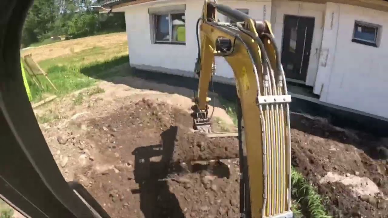 Backfilling of sewer pipe and landscaping. Cat 302.7