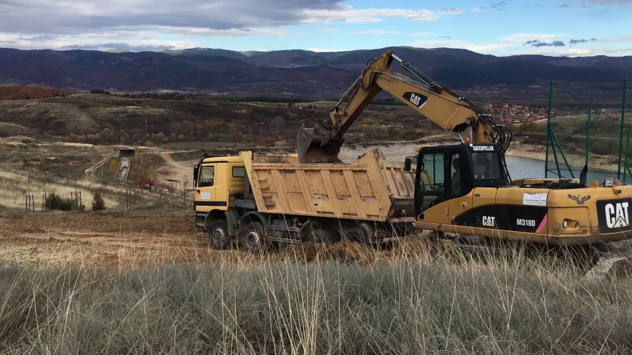 CAT M318D excavator loading a dump truck Mercedes Actros 4143 -2
