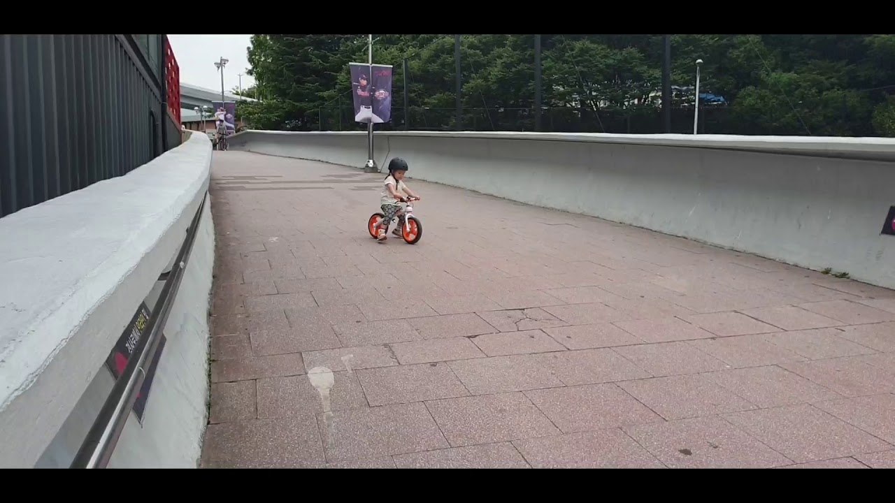Lucy riding a bike at Sajik Baseball Stadium
