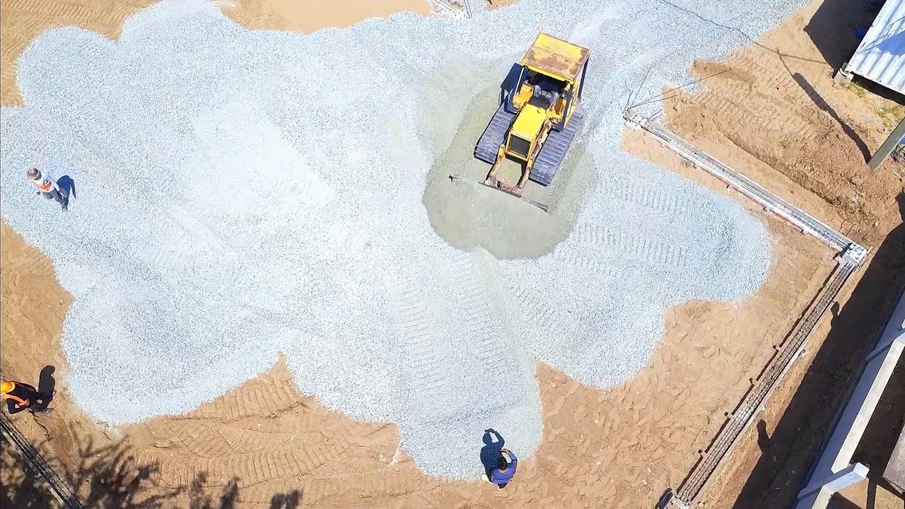 Finished Project. Bulldozer and Dump Truck Teamwork Equipment at Work Perfect Gravel Spreading