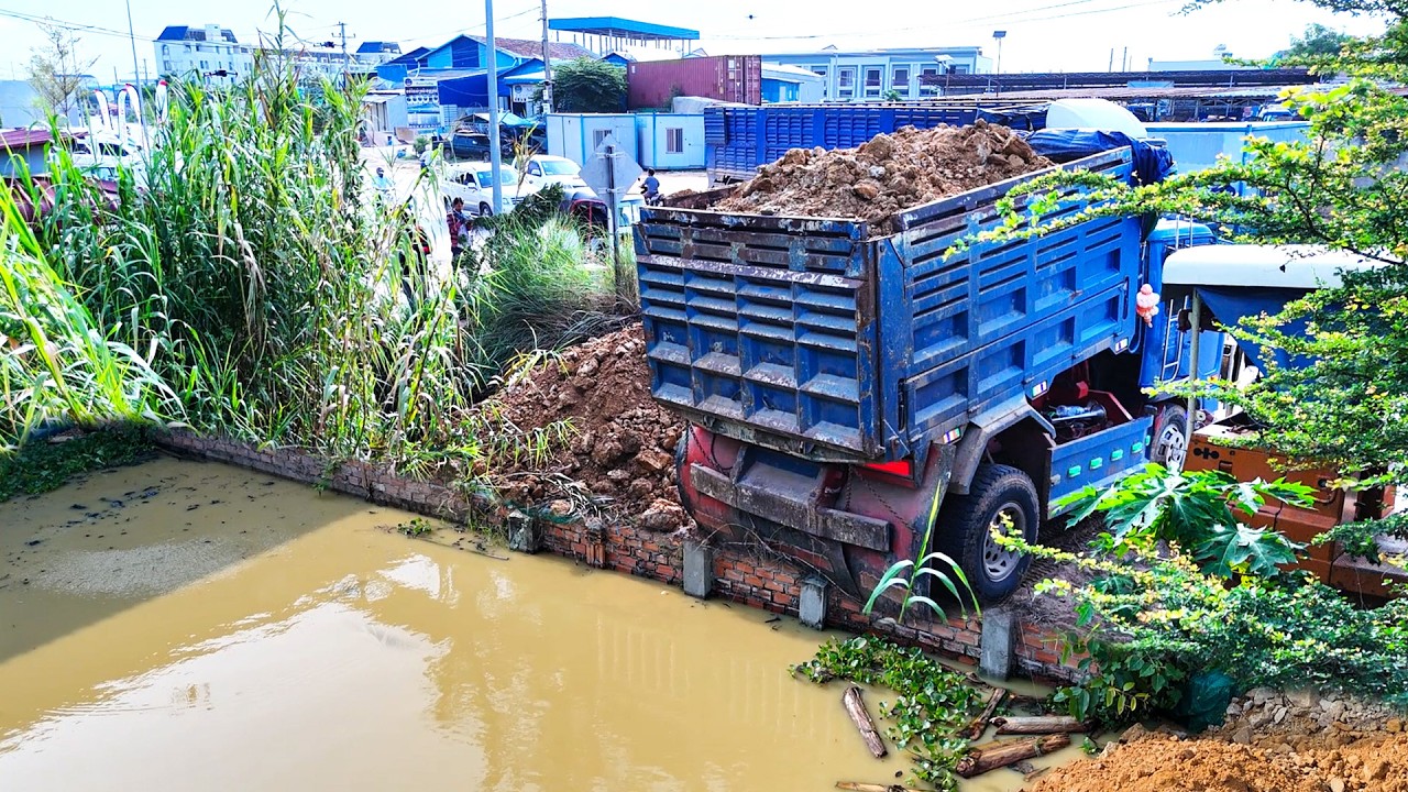 Incredible performance bulldozer filling dirt and soil filling up land and dump trucks 