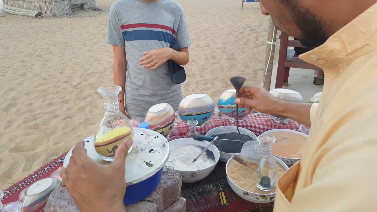 Making sand art in a bottle in Dubai