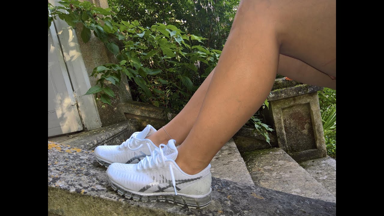Her sockless Asics Quantum 360 and feet on grass.