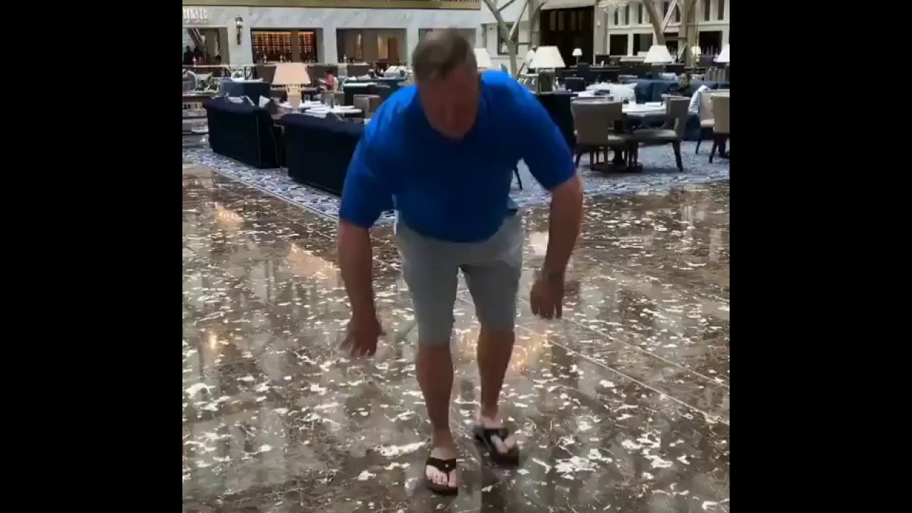 Robert F. Hyde doing push-ups in a hotel lobby