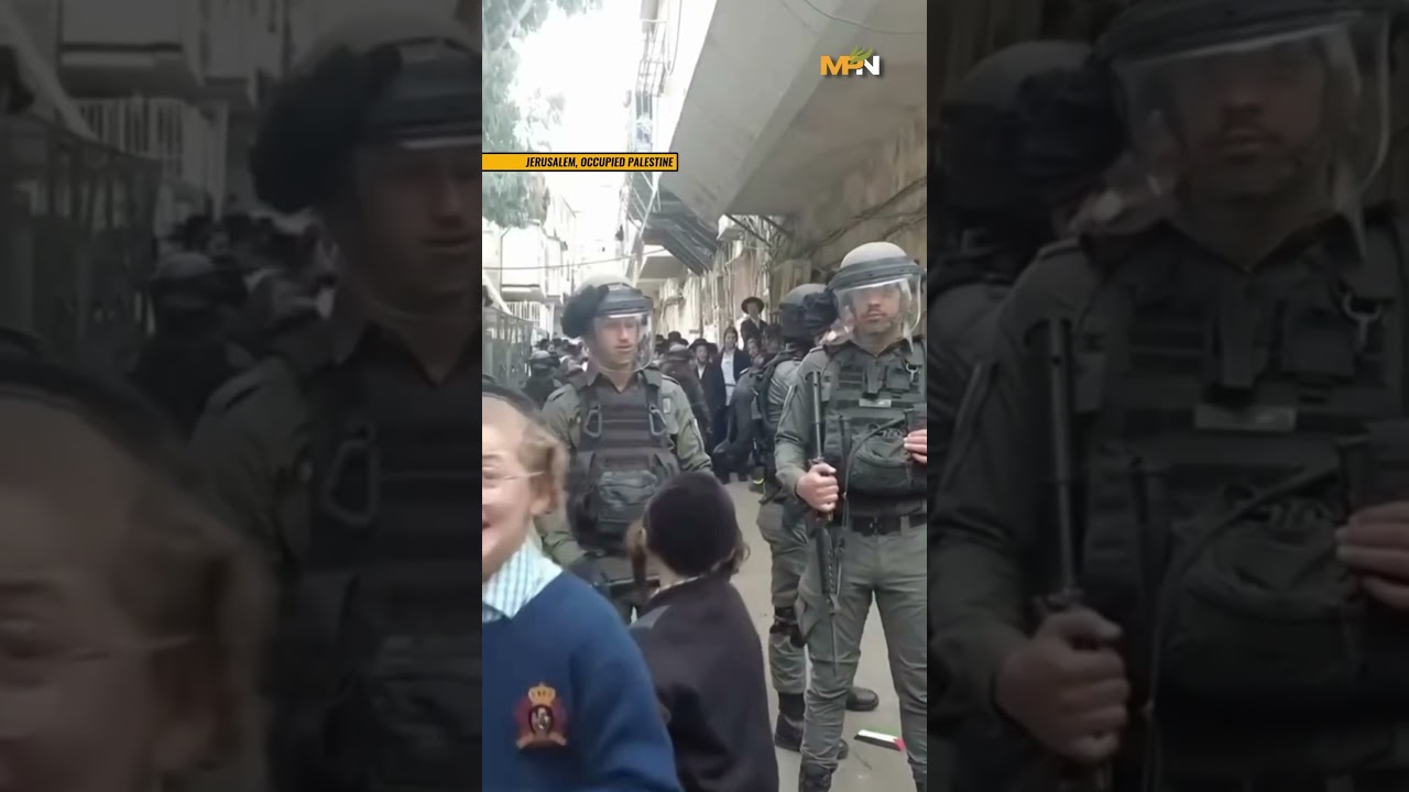 Ultra-orthodox Jews Protest in Jerusalem and hold up the Palestinian flag.