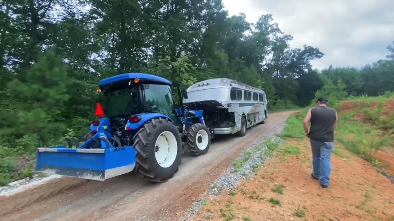 Can a 75hp New Holland Work Master tractor push a 22,000lb bus up a 25% grade hill?