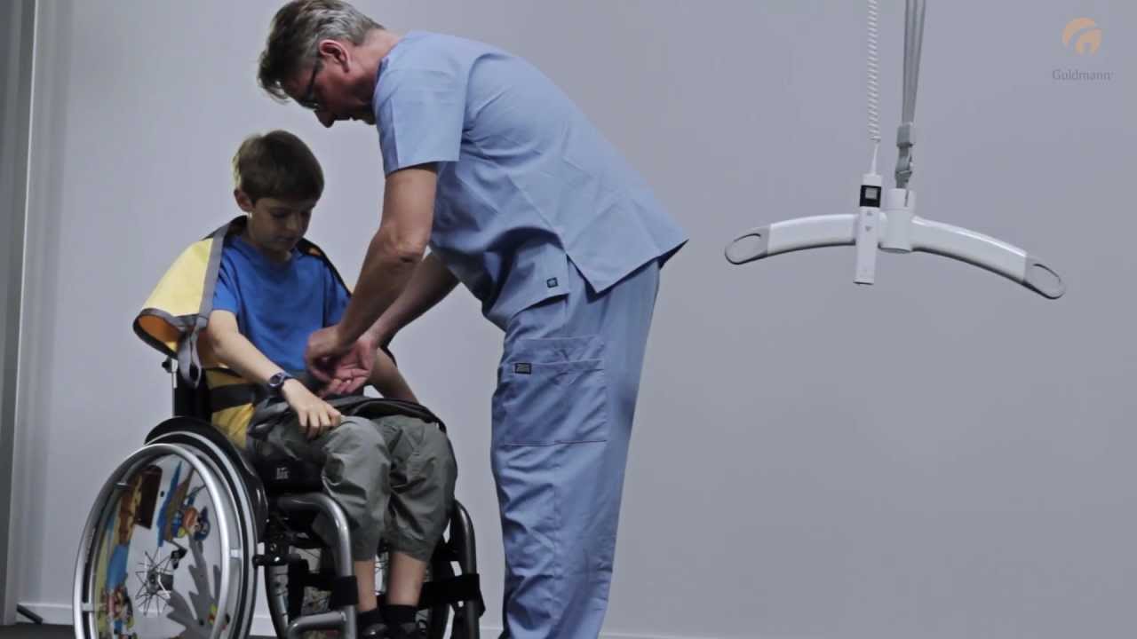 Guldmann Sling Instruction: Kid Basic Basic Sling on/off in wheelchair