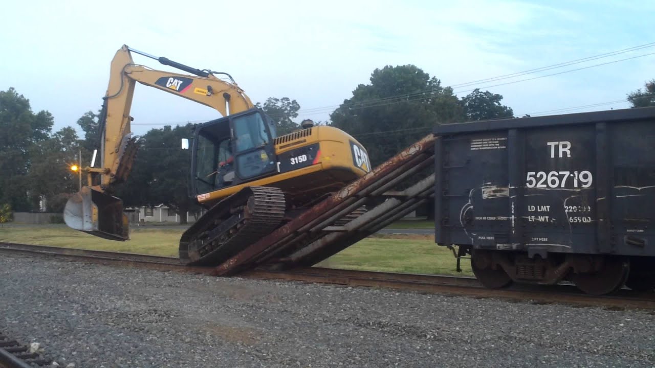 Trackhoe climbing on railcar- Please subscribe to my channel
