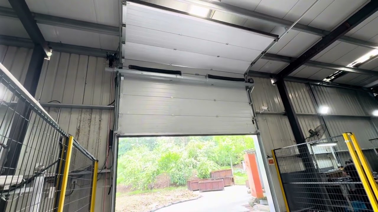 Watch Our Industrial Sectional Door in Action! 🚪💨