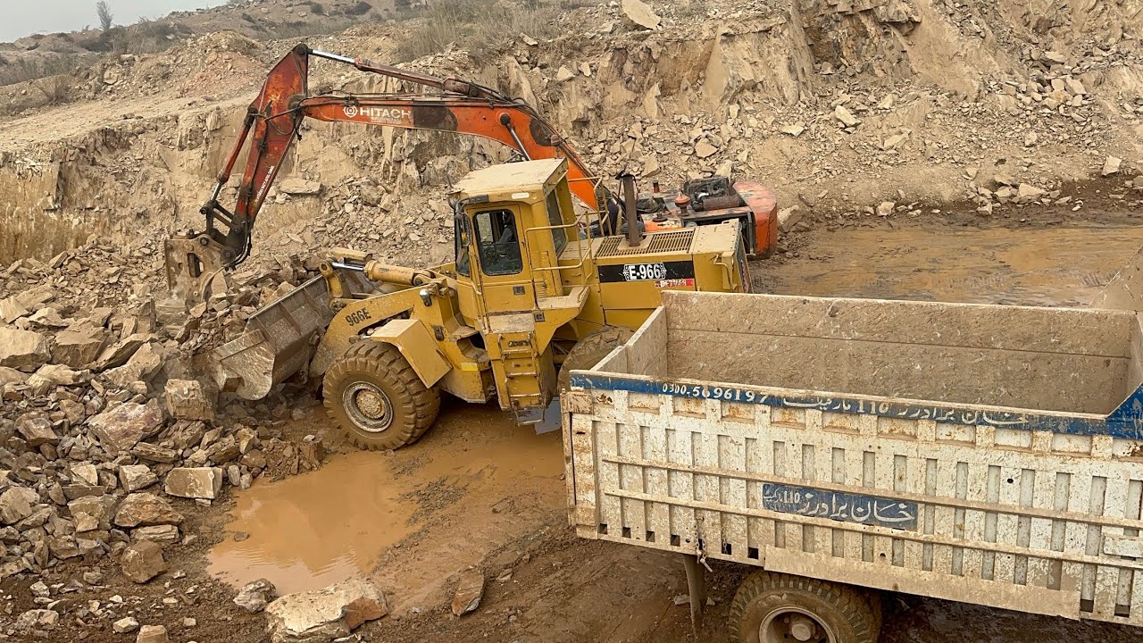 Powerful Caterpillar Loader Loading Giant Stones in Mountain Quarry