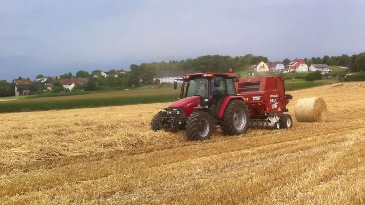 Case JXU 95 mit New Holland Rundballenpresse