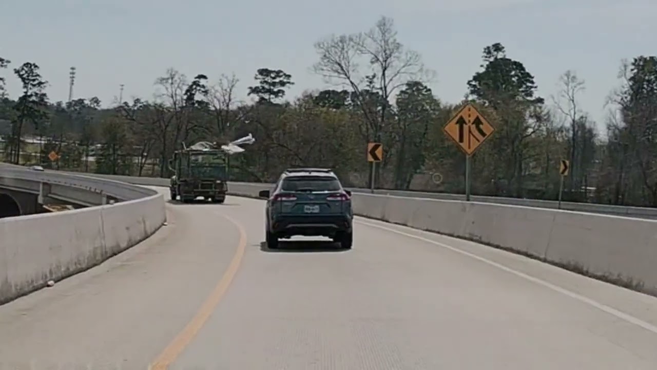 Trash truck loses cargo, near miss