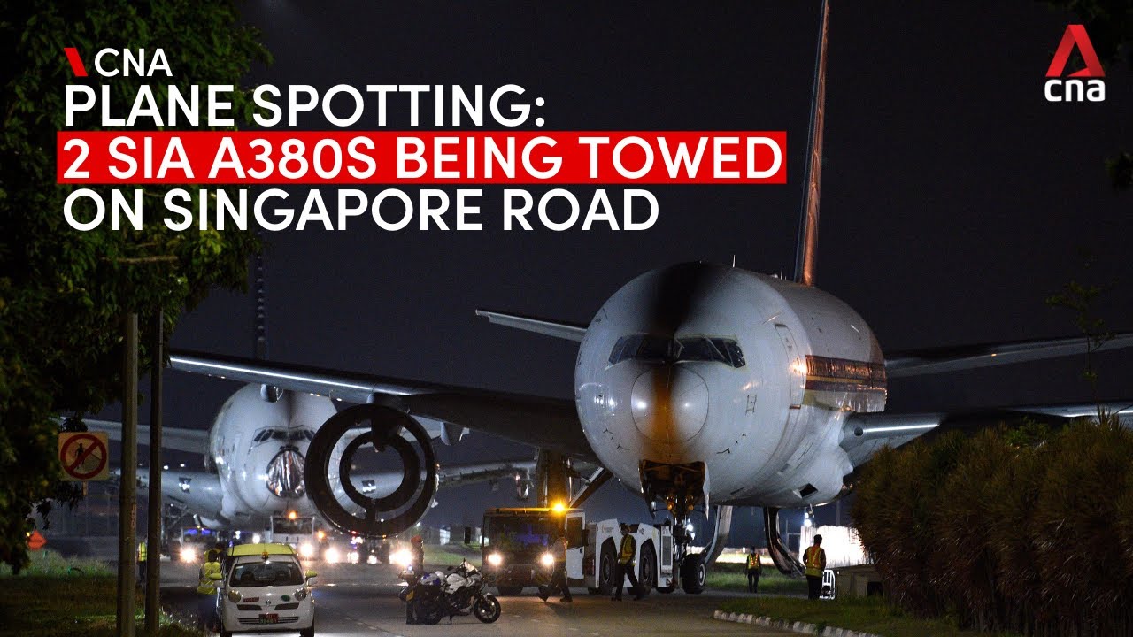 Two Singapore Airlines Airbus A380 planes being towed on Singapore road