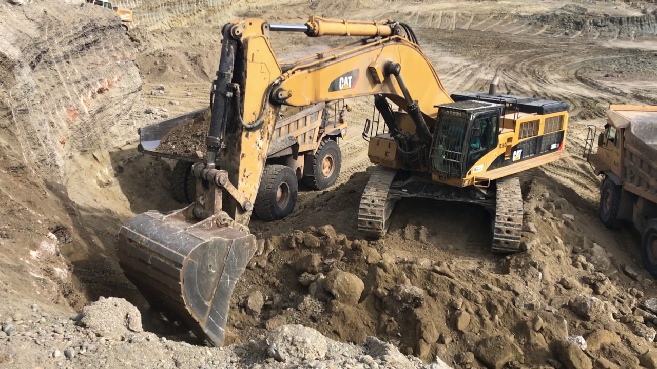Caterpillar 385C Excavator Loading Caterpillar Dumpers