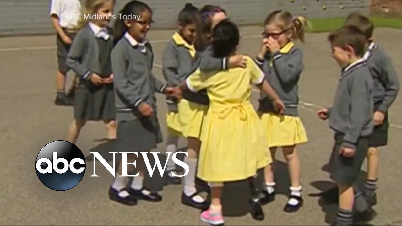 7-year-old Anu shows off her pink prosthetic 'sports blade' to classmates in England