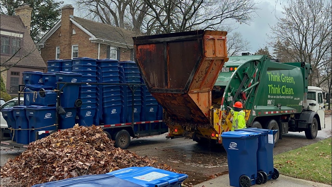 WM Mack McNeilus Rear Loader Garbage Truck Packing Wet Leaf Piles