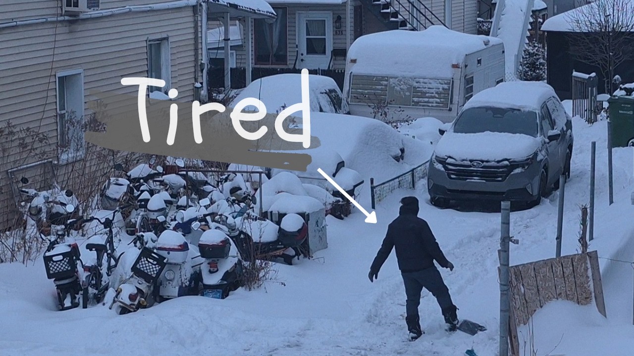 No more shoveling! a Lazy-Man uses his car to brush the snow from driveway.