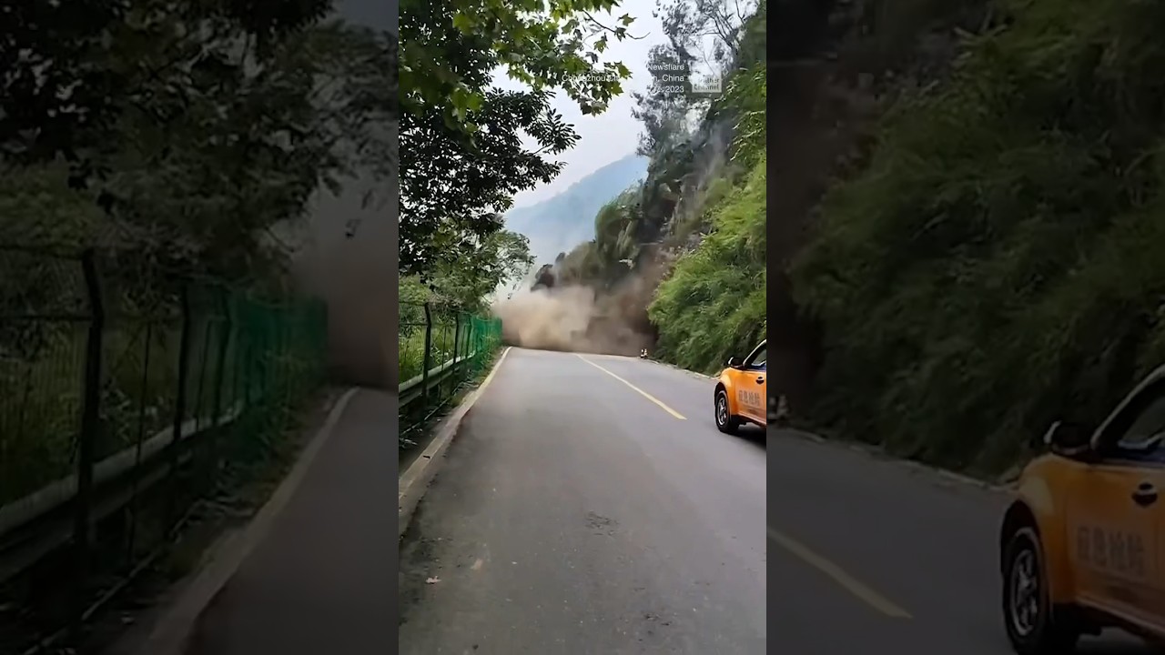 Truck reverses to escape a large landslide